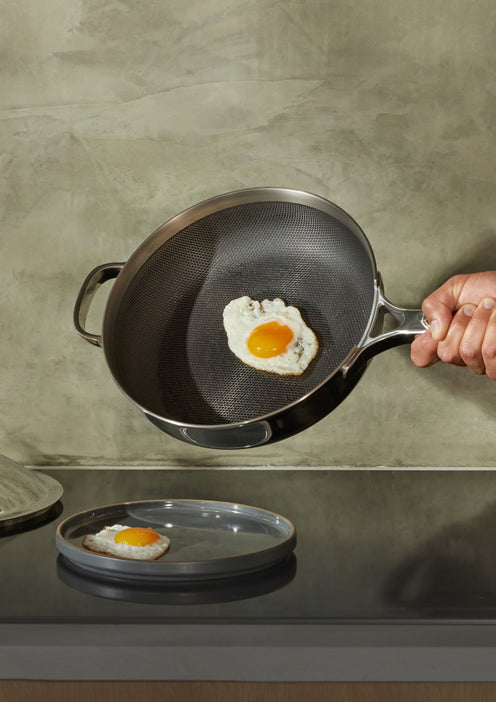 serving egg with titanium always pan pro onto char salad plates