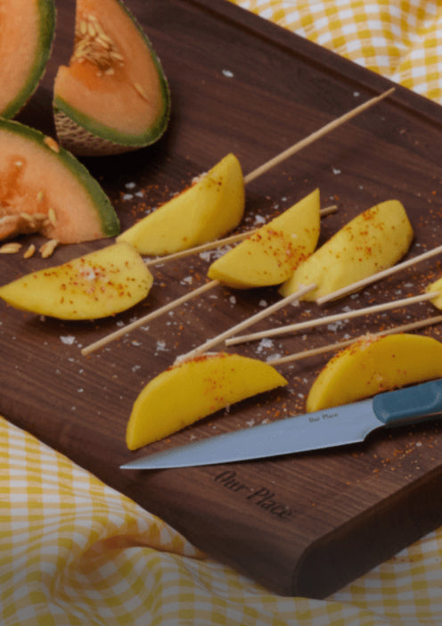 pairing knife on cutting board with fruit