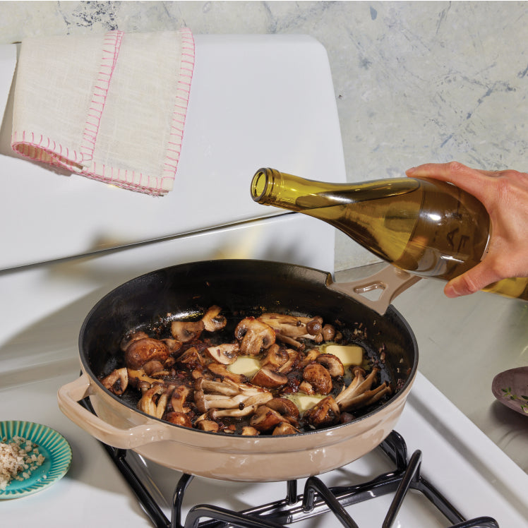 Beige Cast Iron Always Pan on stovetop with mushrooms and wine