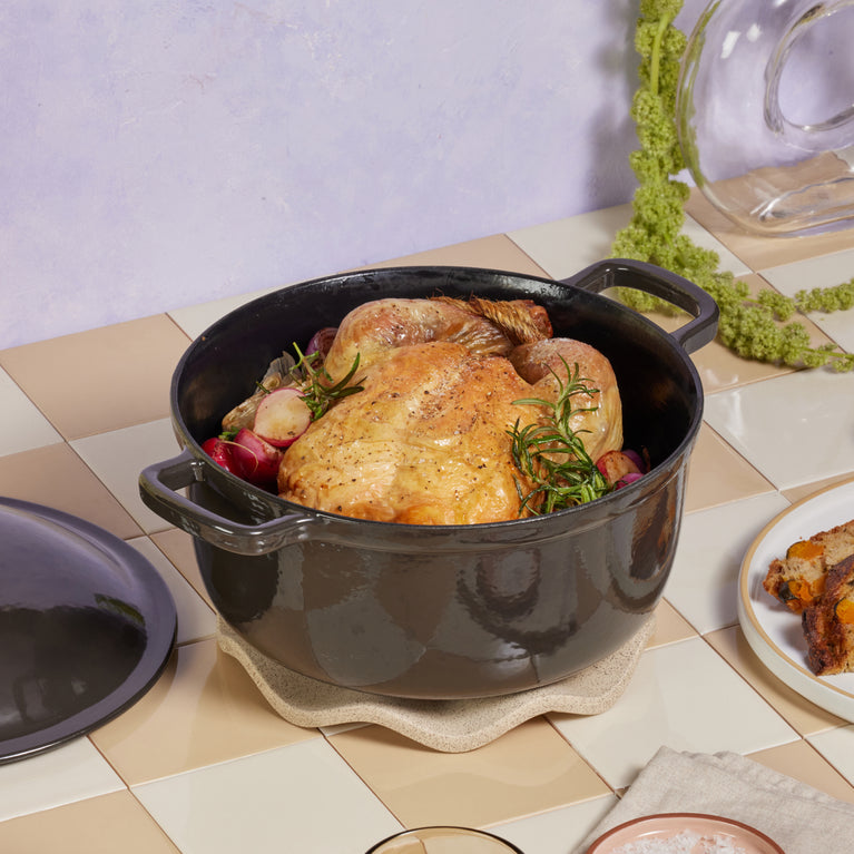 Black Cast Iron Perfect Pot with chicken on countertop