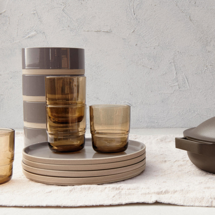 A set of black Main Bowls and Main Plates with drinking glasses