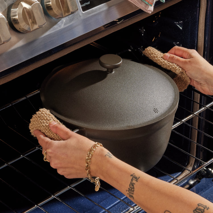 Removing a black Perfect Pot from the oven