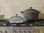 Two pots on a gas stove with a neutral background