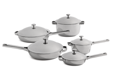 Set of stainless steel cookware with lids on a white background