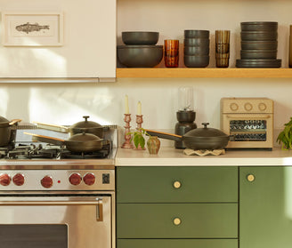 black our place dinnerware and cookware on stove and counters