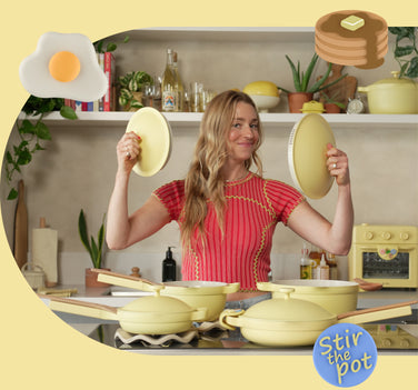 Woman in a kitchen holding yellow pots and pans with 'Stir the Pot' branding.