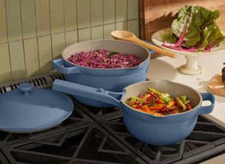 blue perfect pot and mini perfect pot on stove cooking vegetables