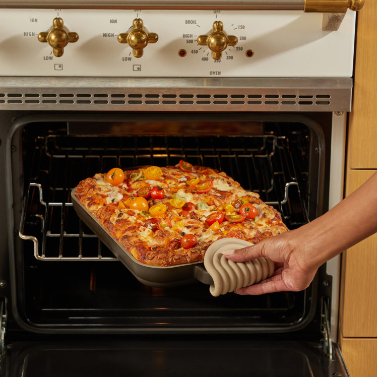 baking focaccia bread on black griddle pan in oven