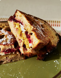 Grilled cheese sandwich with jelly on a green plate