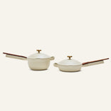 The Mini Cookware Duo includes a beige nonstick deep saucepan and shallow skillet with matching lids and wooden handles, shown side by side. These bestsellers are perfect for versatile, everyday cooking.
