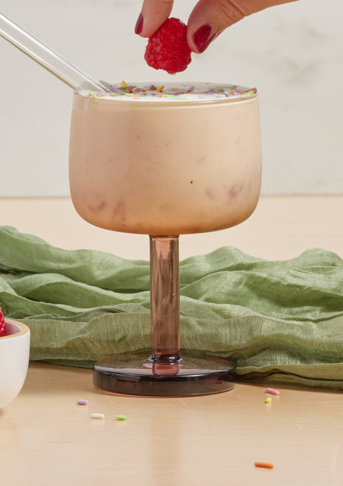 party coupe filled with parfait with straw