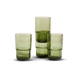 Four green glass tumblers are stacked and arranged against a plain white background.