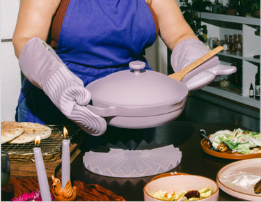 lavender hosting apron, hot mitts, and always pan serving food on table