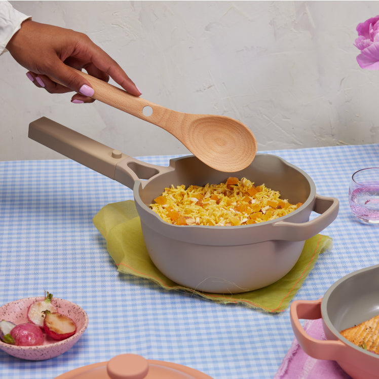 Serving rice in a beige Mini Perfect Pot on a blue table