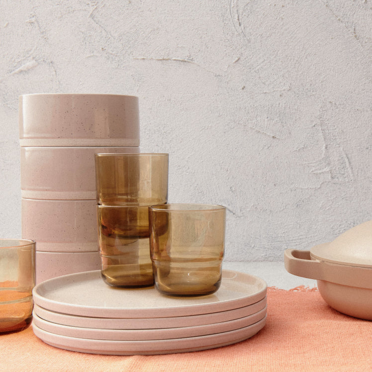 A set of beige Main Bowls and Main Plates with drinking glasses