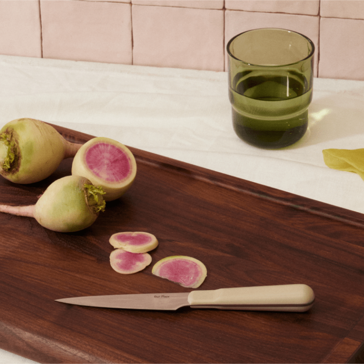 Beige Precise Paring Knife on top of the Walnut Cutting Board with radish