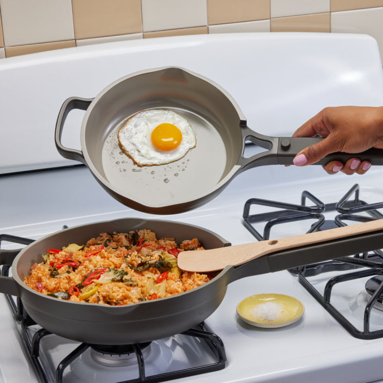 black always pan and mini always pan on a stovetop with rice and egg