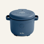 A blue electric rice cooker with a digital display and side handles, labeled Our Place, set against a plain light background.