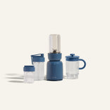 Blue portable blender with clear containers on a white background