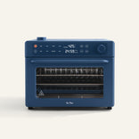 A blue countertop oven with digital controls displaying 425°F and 24:59, featuring a transparent door and multiple wire racks.