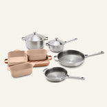 Titanium Pro Cookware + Bakeware Set 2.0 featuring a collection of high-performance stainless steel cookware with lids and several ceramic bakeware dishes in various sizes.