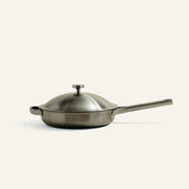 A stainless steel Titanium Always Pan Pro 10.5″ 2.0 skillet with a matching lid and a long handle.