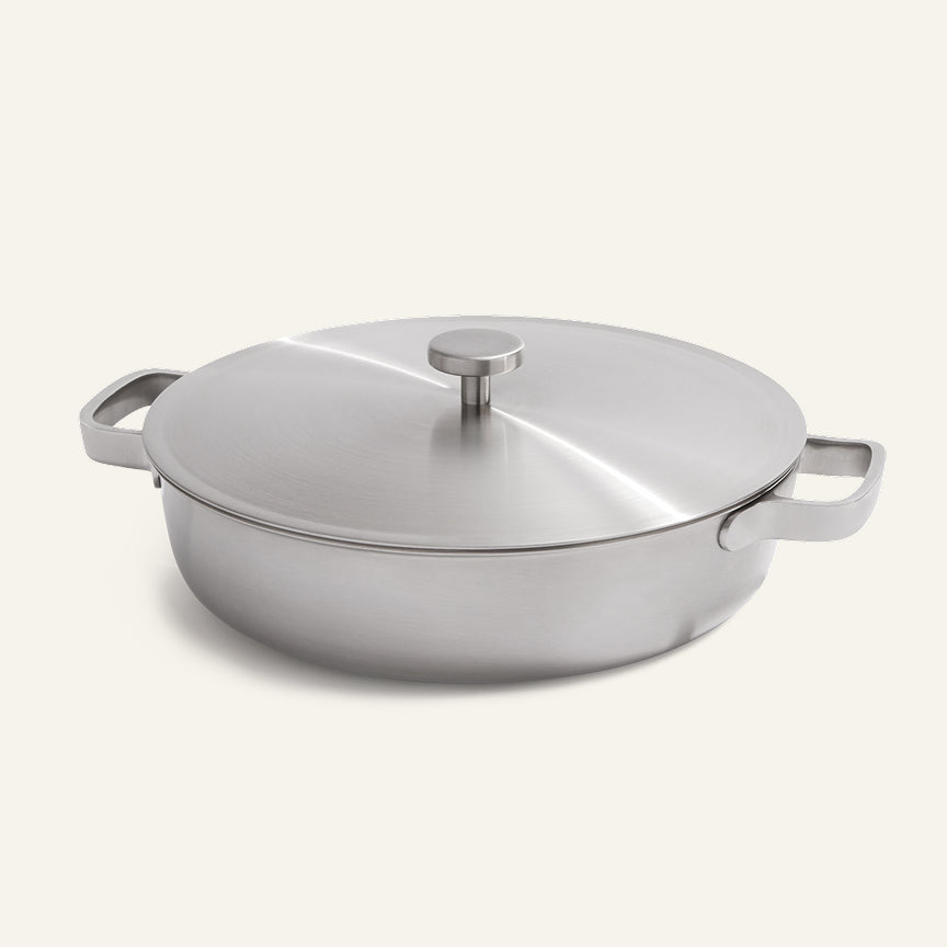 The Titanium Braiser Pro, a wide, shallow braiser with two side handles and a lid.