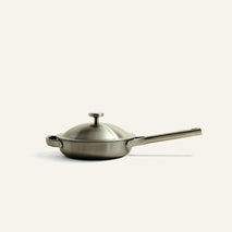 A Titanium Always Pan Pro 8.5″ 2.0 stainless steel pan with a matching lid, a long handle, and a small side handle.