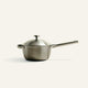 A brushed metal Titanium Perfect Pot Pro 3 qt. saucepan with a matching lid and a long handle.