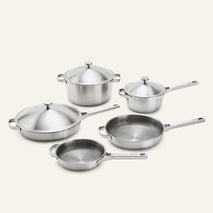 Titanium Pro Cookware Set+ 2.0 stainless steel cookware including a Dutch oven, saucepan, sauté pan, and two skillets, all with matching lids.