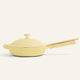 A light yellow Ceramic Nonstick Always Pan 10.5” with a matching lid and a wooden spatula resting on the handle, set against a plain background.