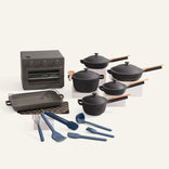 Set of black cookware including pots, pans, and utensils on a white background