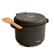 A black electric rice cooker with a wooden spatula resting on top of the closed lid, placed against a plain white background.