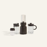 Black portable blender with clear containers on a white background