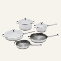 A set of five Titanium Pro Cookware Set+ 2.0 stainless steel pots and pans, some with matching lids.