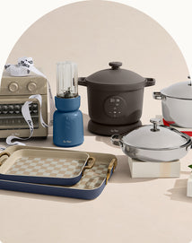 Collection of kitchen appliances including a blender, slow cooker, and cookware on a beige background.