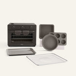 Set of black kitchen appliances and cookware on a white background