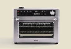 Stainless steel oven with digital display on a beige background