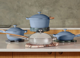 blue salt perfect pot,  mini perfect pot on stove, sage mini always pan and titanium always pan pro on counter