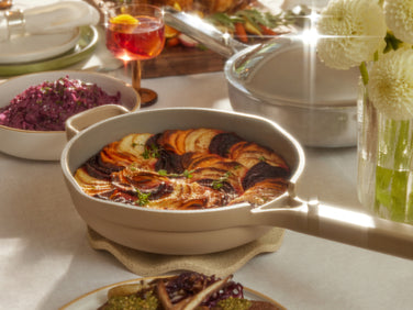 beige always pan with cooked food set on table