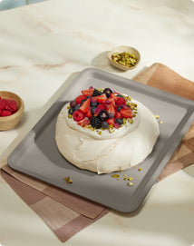 Saffron Pavlova with Berries on black large wonder oven tray