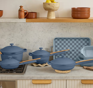 blue perfect pot and mini always pan on stove, blue mini perfect pot, always pan, griddle pan and bakeware set on counter