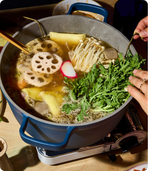 soup cooking in blue perfect pot non toxic nonstick dutch oven on stove