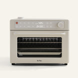 Beige oven with digital display on a white background