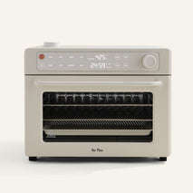 Beige oven with digital display on a white background