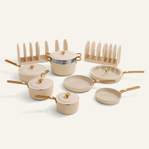 Set of ceramic cookware with gold handles on a white background