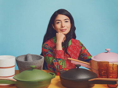 our place founder shiza shahid with dinnerware and cookware assortment