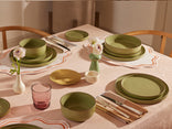 sage dinnerware assortment on table