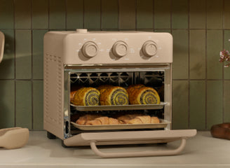 beige wonder oven on stove cooking croissants 