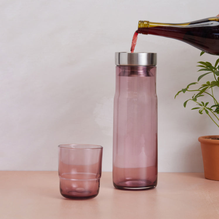 Pouring wine through the aerator of a pink Night + Day Carafe